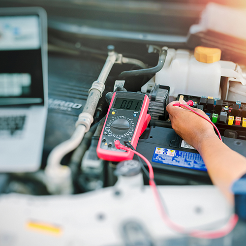 Close up of auto mechanic jumping battery car