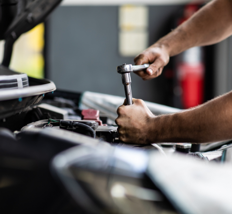 male mechanic repairs car in garage